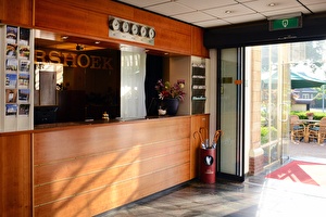 Amrâth Hotel Lapershoek Arenapark entrance reception, wooden counter for receiving guests.